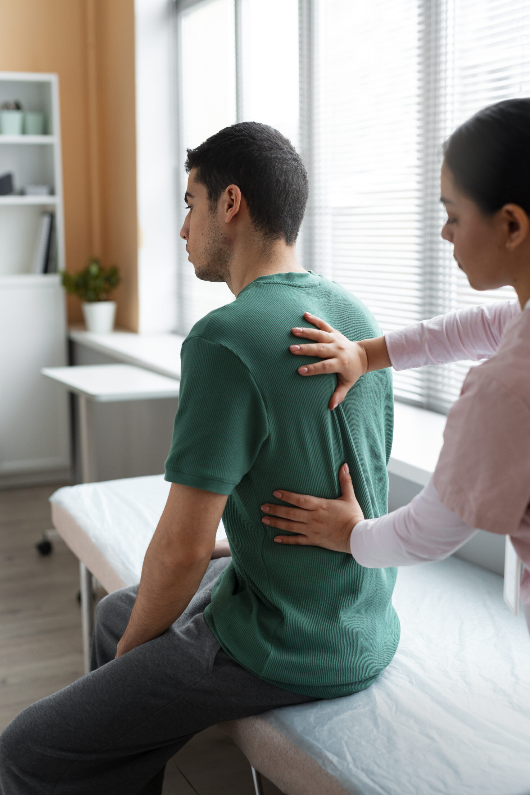 doctor helping patient rehabilitation scaled