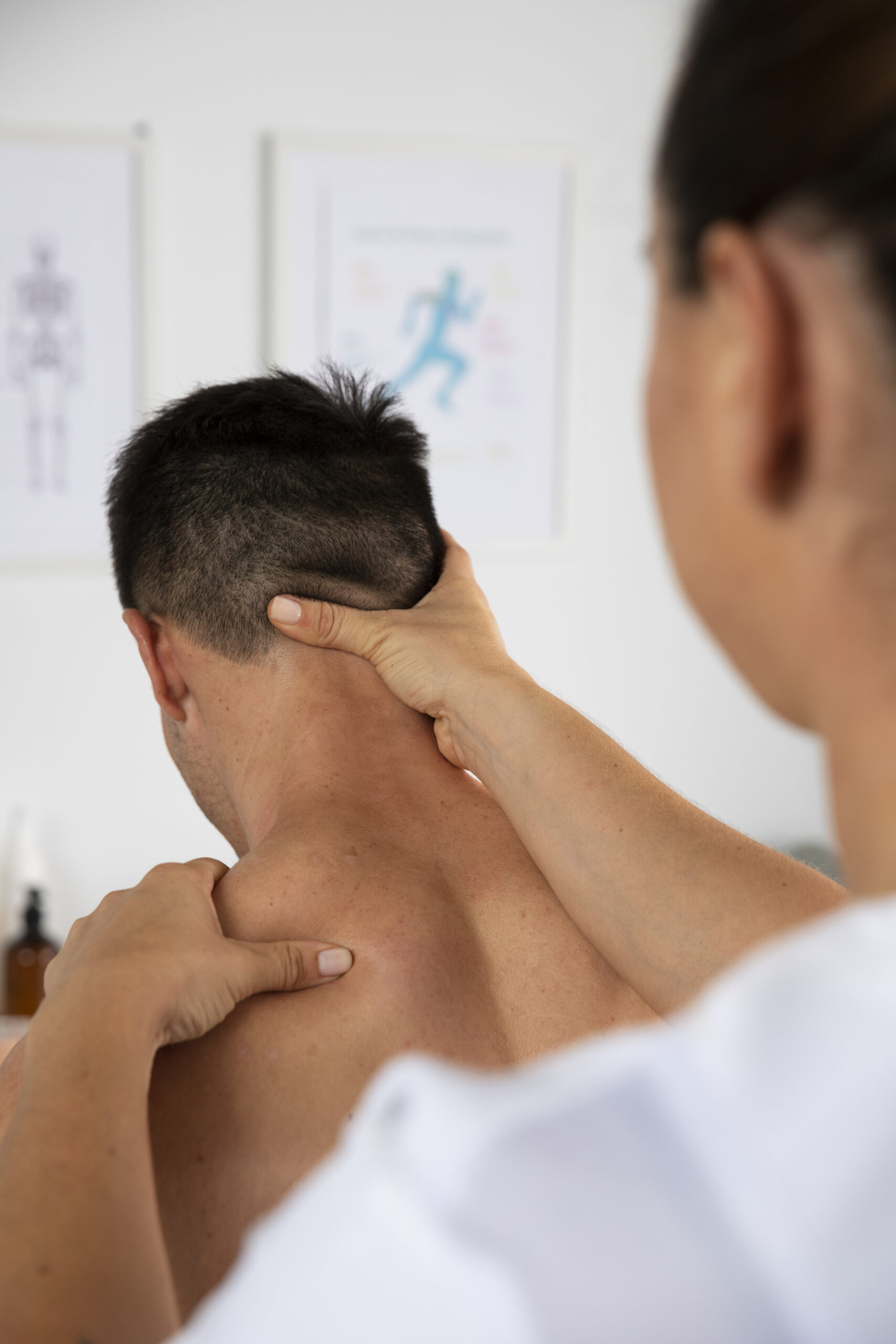 physiotherapist performing therapeutic massage male client scaled
